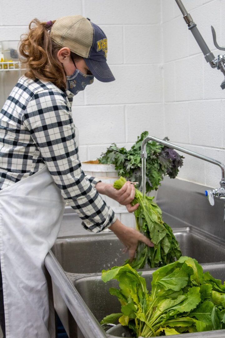 Volunteer washing lettuce